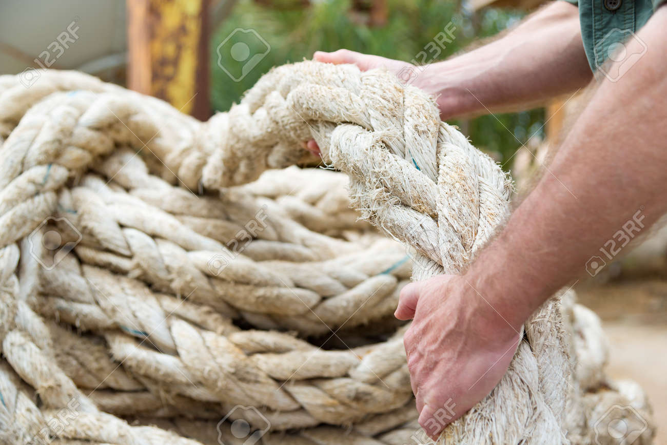28292364-Two-hands-pulling-a-big-rope-of-ship-Stock-Photo.jpg