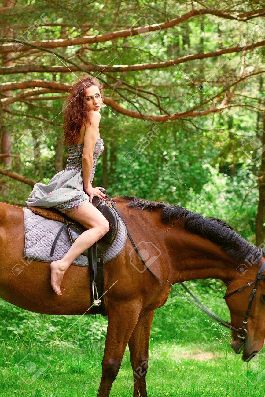 13845489-beautiful-young-girl-on-horse-in-dress-in-forest-Stock-Photo.jpg