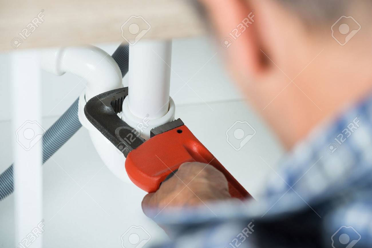 cropped image of plumber fixing sink pipe with adjustable wrench in kitchen stock photo 47562186 - Kitchen Sink Wrench cropped image of plumber fixing sink pipe with adjustable wrench in kitchen stock photo 47562186 - Kitchen Sink Wrench