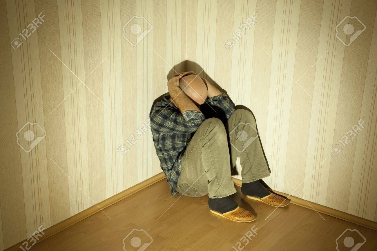 12358211-lonely-man-in-angle-ill-on-depression-Stock-Photo.jpg