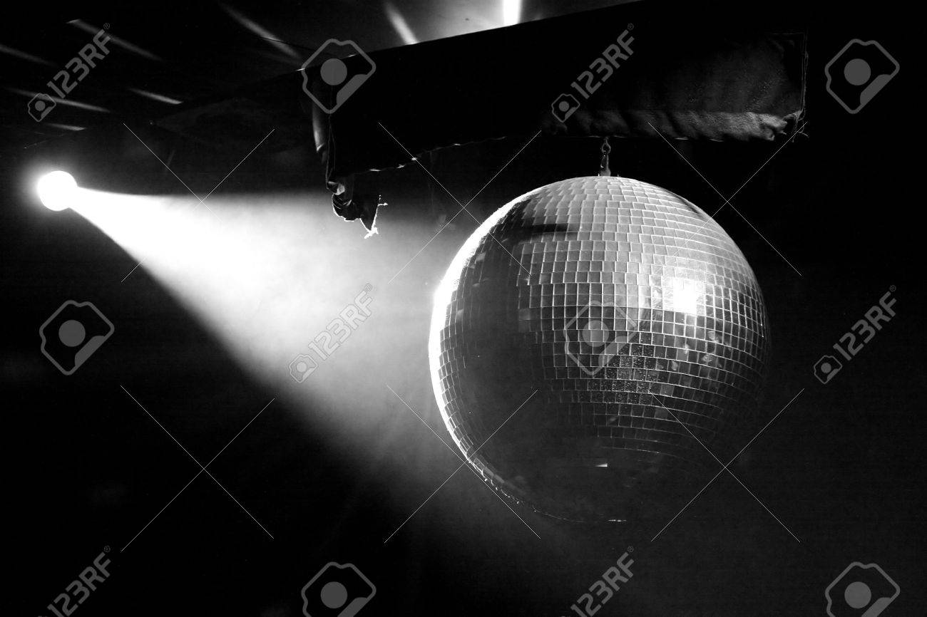 1463714-A-lit-mirrored-disco-ball-in-smoky-room-in-black-and-white-Stock-Photo.jpg