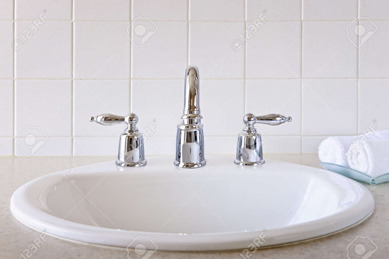 archivio fotografico interno del bagno con lavandino bianco e rubinetto