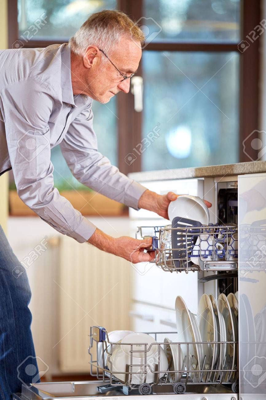 Senior Man Empty Out The Dishwasher Stock Photo, Picture And ...