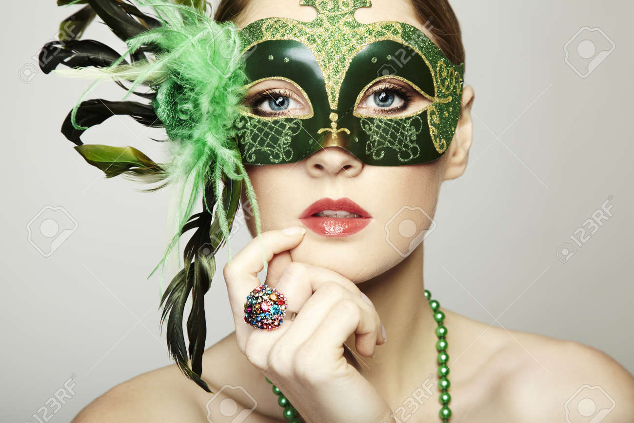 11927870 The beautiful young woman in a green mysterious venetian mask  Stock Photo