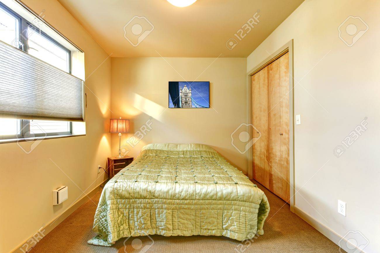 Petit intérieur jaune chambre d'amis avec lit vert. banque d ...