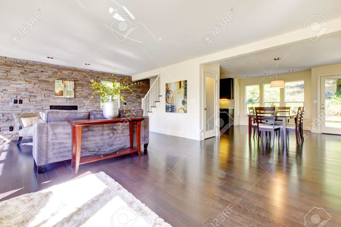 Beautiful modern large bright living room with dark floor and ...