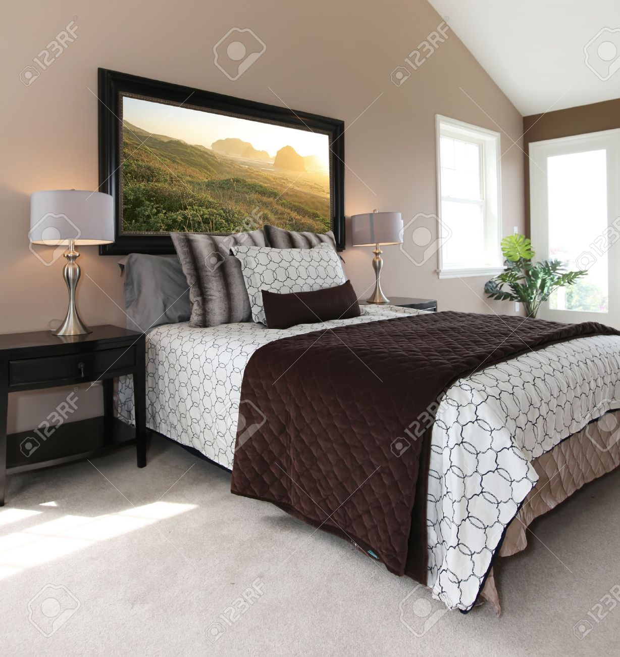 Slaapkamer met een moderne witte en bruine bed en nachtkastjes ...