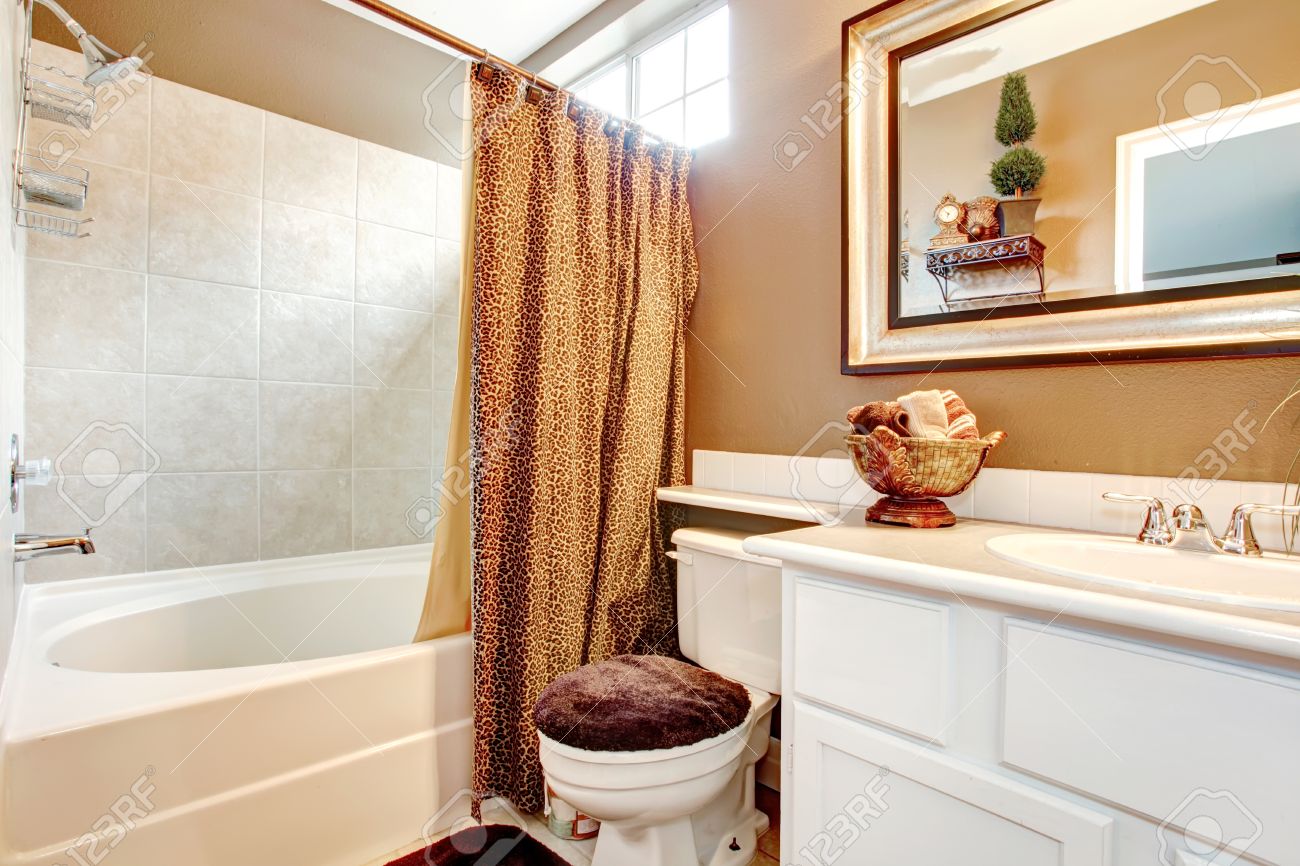 Salle de bains de mur beige avec meuble vasque blanc, miroir ...