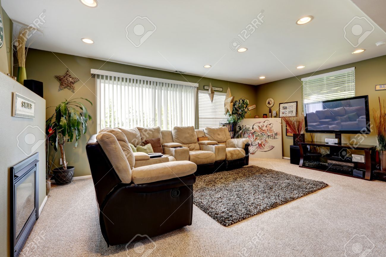Olijf muren woonkamer met zachte tapijt, comfortabele bank set, tv ...