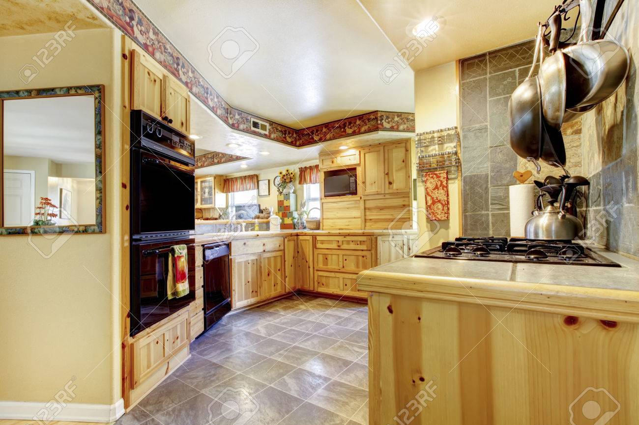 Rustic Kitchen With Gold Wooden Cabinets, Black Appliances And Rustic Kitchen With Gold Wooden Cabinets, Black Appliances And