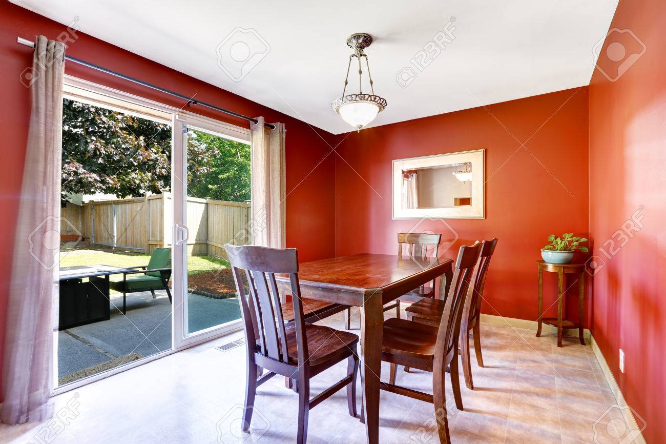 Salle à manger avec des murs rouge vif et débrayage patio. vieux ...
