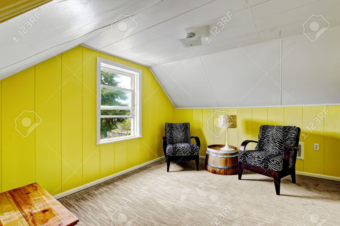 Chambre jaune clair avec du blanc plafond voûté. coin salon avec ...
