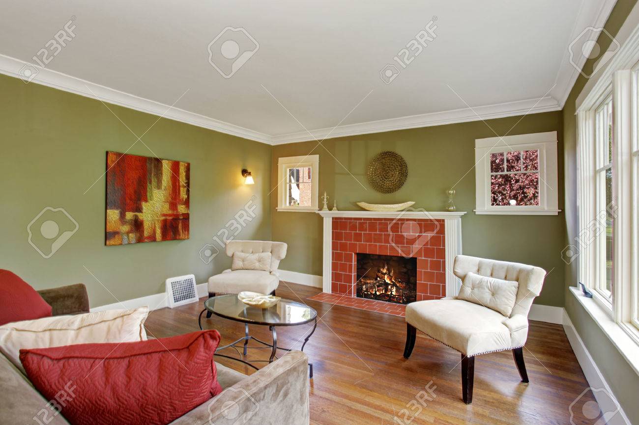 Olive Tone Family Room With Fireplace, Two White Chairs, Sofa Olive Tone Family Room With Fireplace, Two White Chairs, Sofa