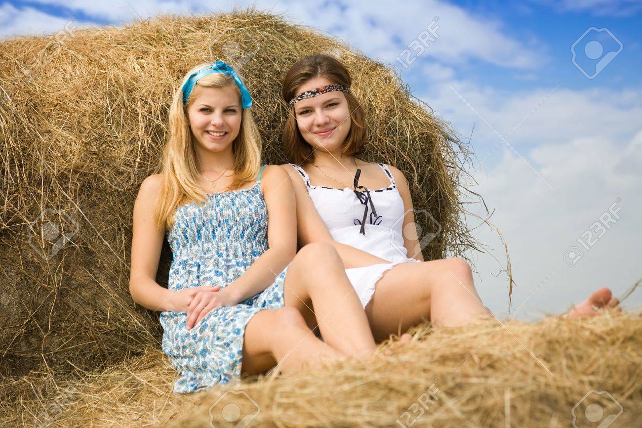 http://previews.123rf.com/images/jackf/jackf1105/jackf110500444/9547054-Farm-girls-resting-on-fresh-hay-bale-Stock-Photo.jpg