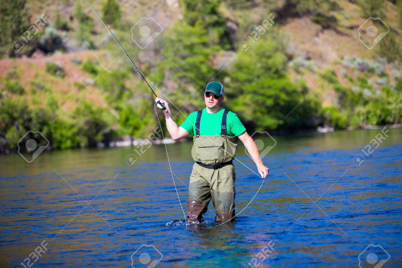 29264937-Experienced-fly-fisherman-fishing-the-Deschutes-River-in-Oregon-casting-for-fish-while-standing-in-t-Stock-Photo.jpg