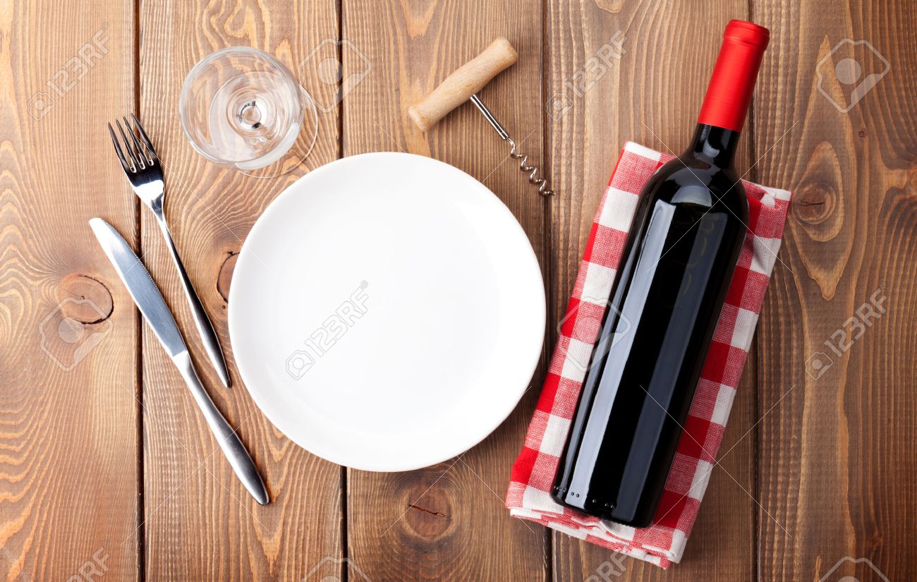 37621002-Table-setting-with-empty-plate-wine-glass-and-red-wine-bottle-Top-view-over-rustic-wooden-table-back-Stock-Photo.jpg