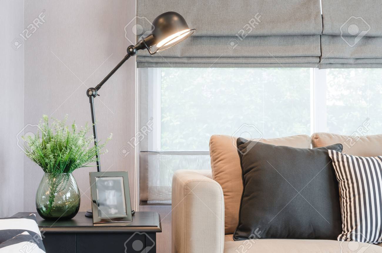Modernes wohnzimmer mit schwarzen lampe auf dem tisch seite und glas vase von pflanzen lizenzfreie