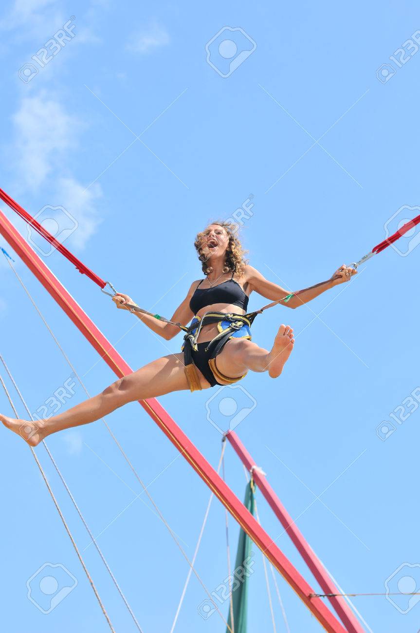 http://previews.123rf.com/images/lexmomot/lexmomot1311/lexmomot131100051/23763923-jumping-girl-on-the-trampoline-at-the-funfair-Stock-Photo.jpg