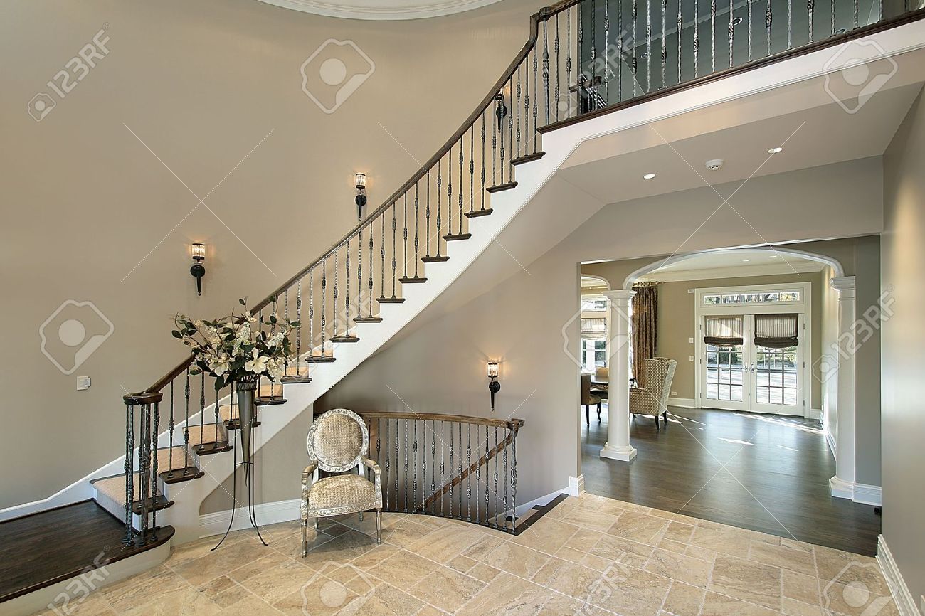 Foyer in luxury home with curved staircase stock photo, picture ...