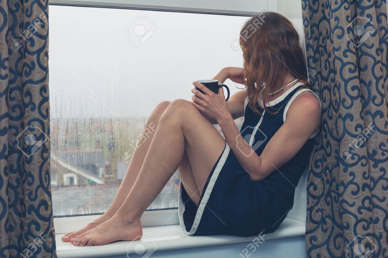 39966307-A-young-woman-is-sitting-on-a-w