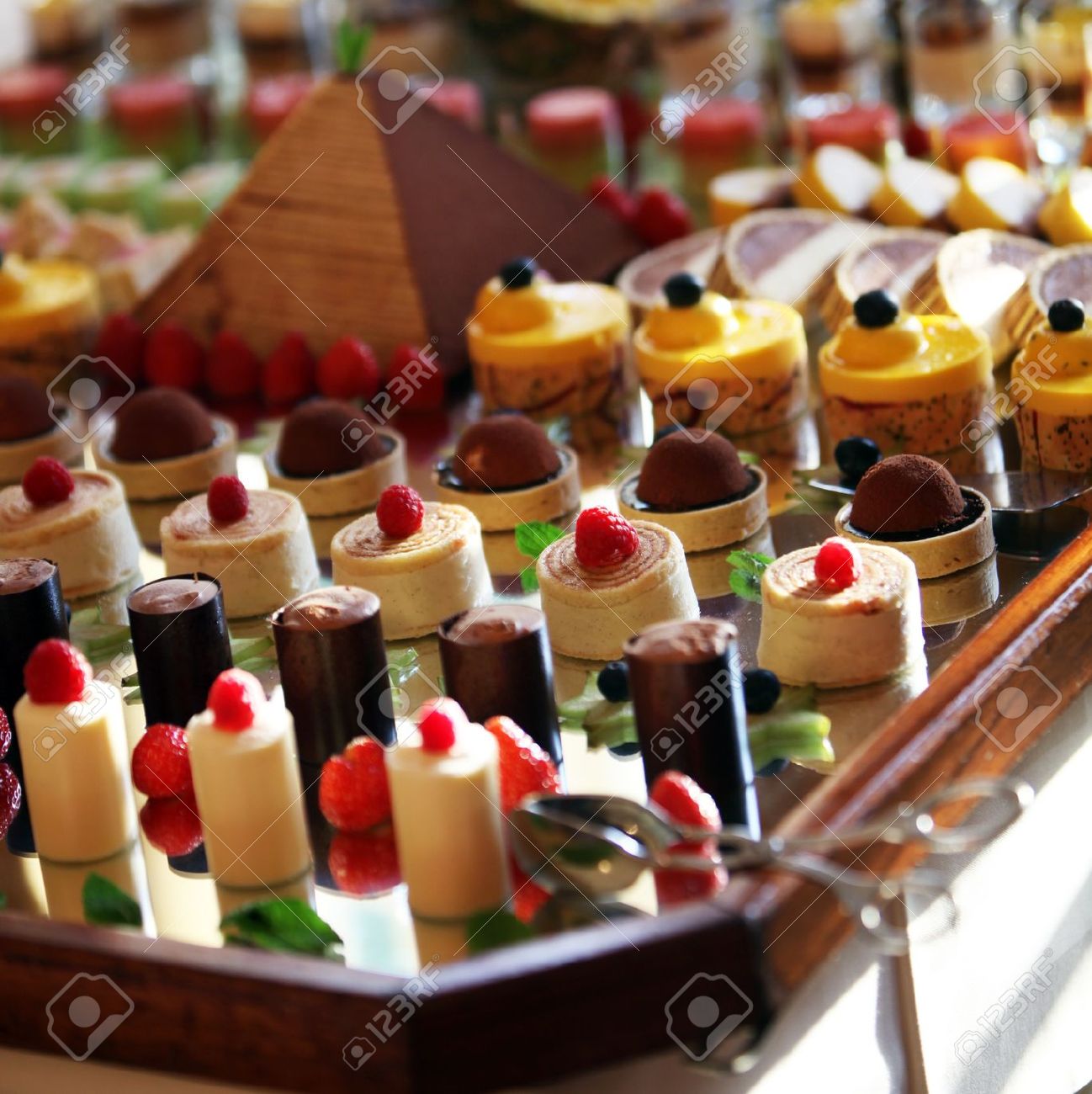 Selection of decorative desserts on a buffet table at a catered ...