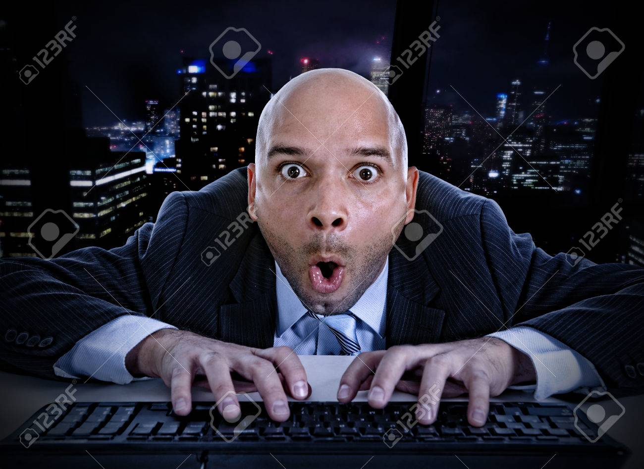 Young Businessman Late At Night In Office Typing On Computer ...