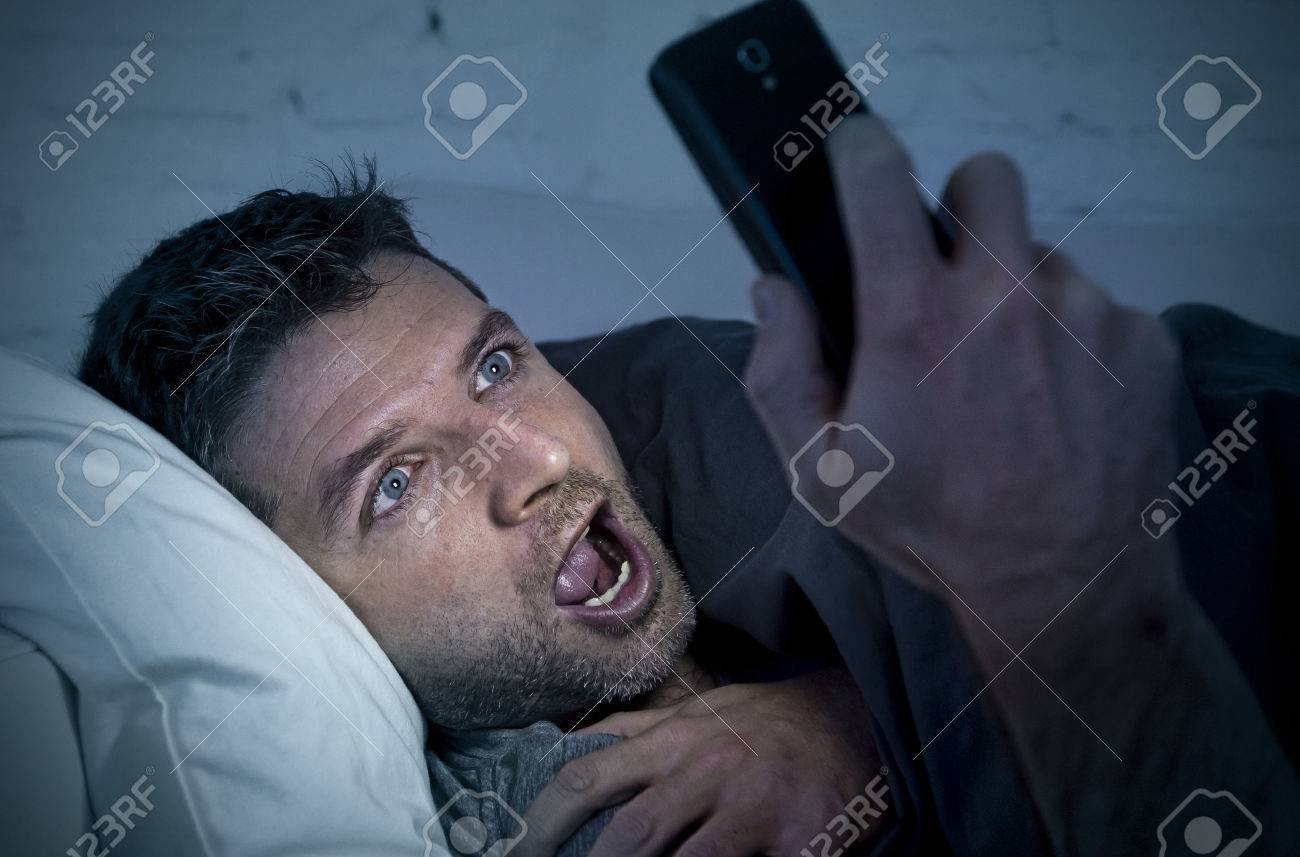 Young Man In Bed Couch At Home Late At Night With Intense Face ...