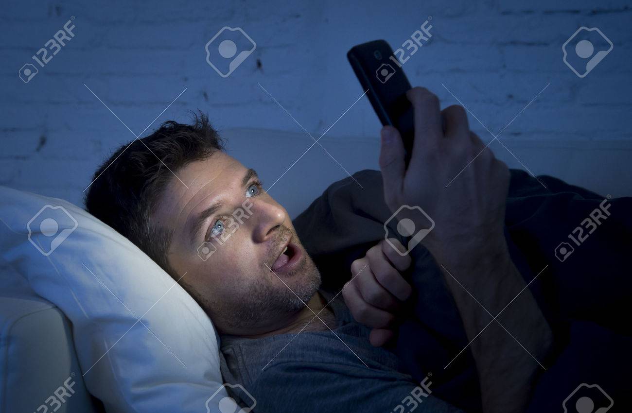 Young Man In Bed Couch At Home Late At Night With Intense Face ...