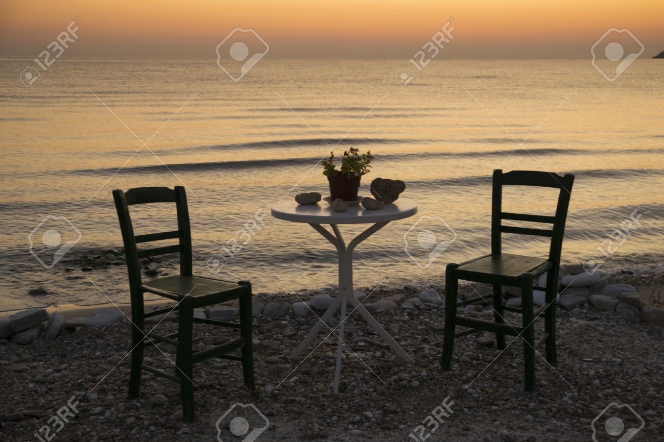 Due sedie vuote e un tavolo in piedi solo nel sole pacifico di una ...