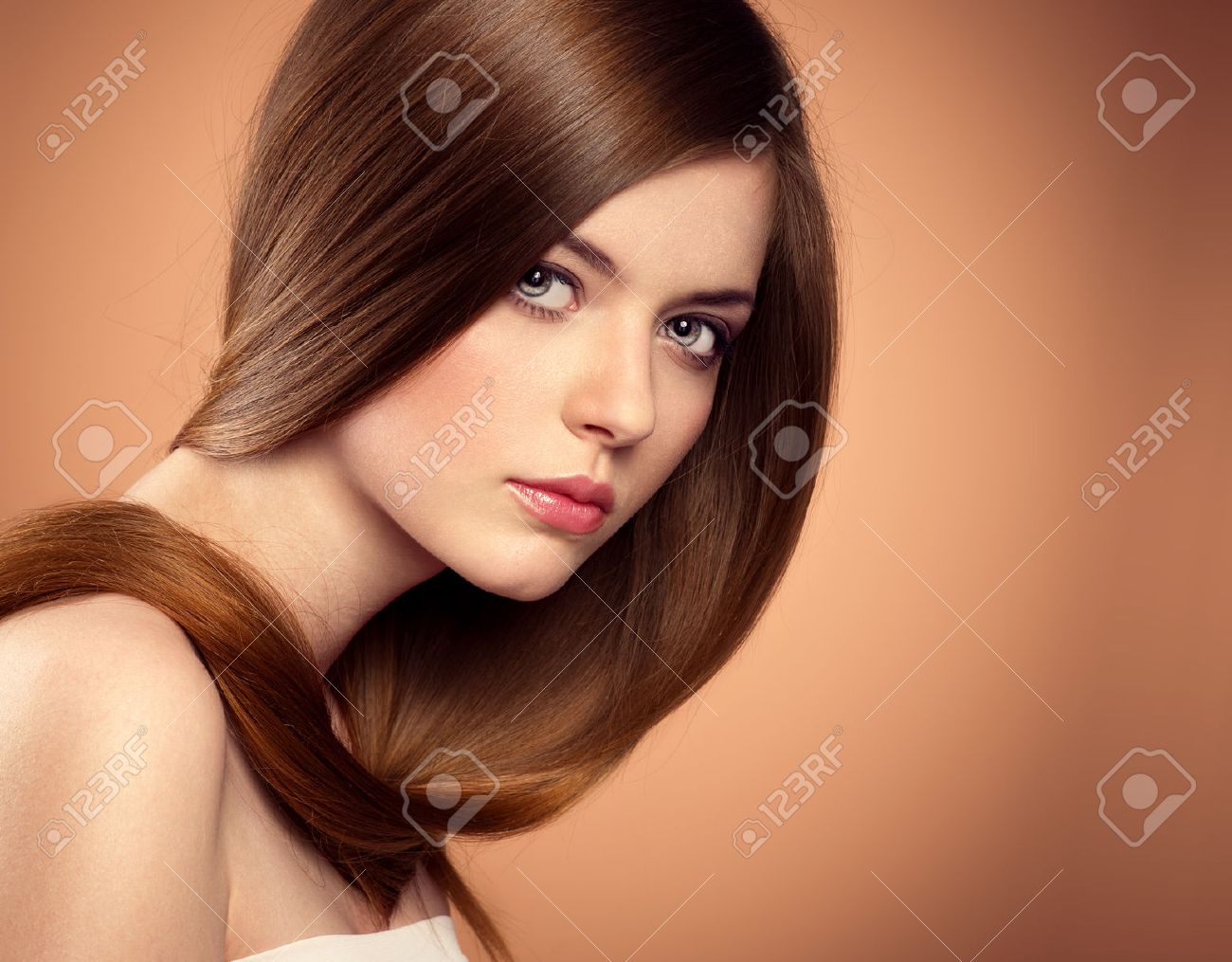 Schoonheidssalon model met perfecte lange glanzende bruine haar ... Slaapkamer donker meubilair