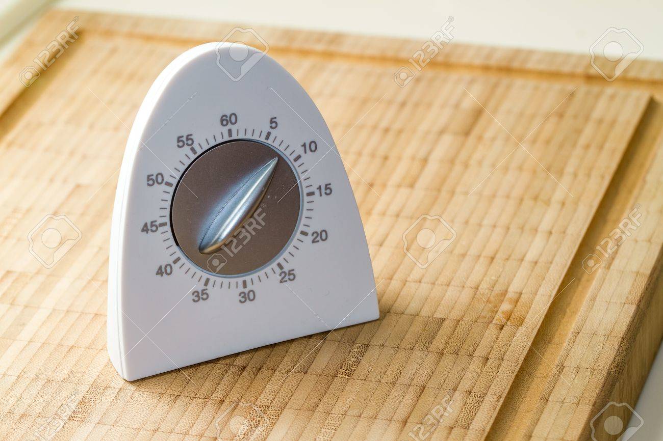 White Modern Kitchen Timer On A Wooden Cutting Board Stock Photo - Stock Photo White Modern Kitchen Timer On A Wooden Cutting Board white modern kitchen timer on a wooden cutting board stock photo - stock photo white modern kitchen timer on a wooden cutting board