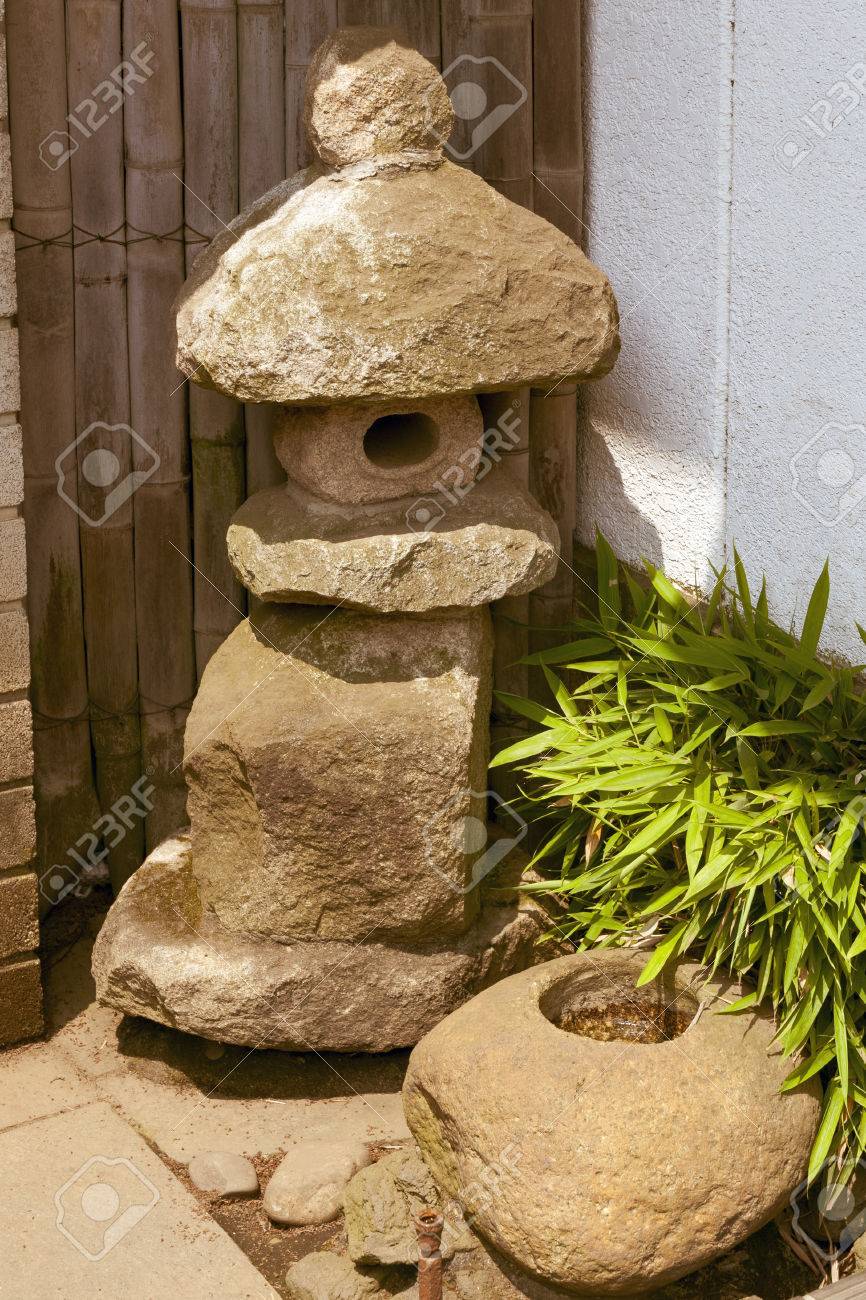 Stock photo traditional small stone lantern near japanese house