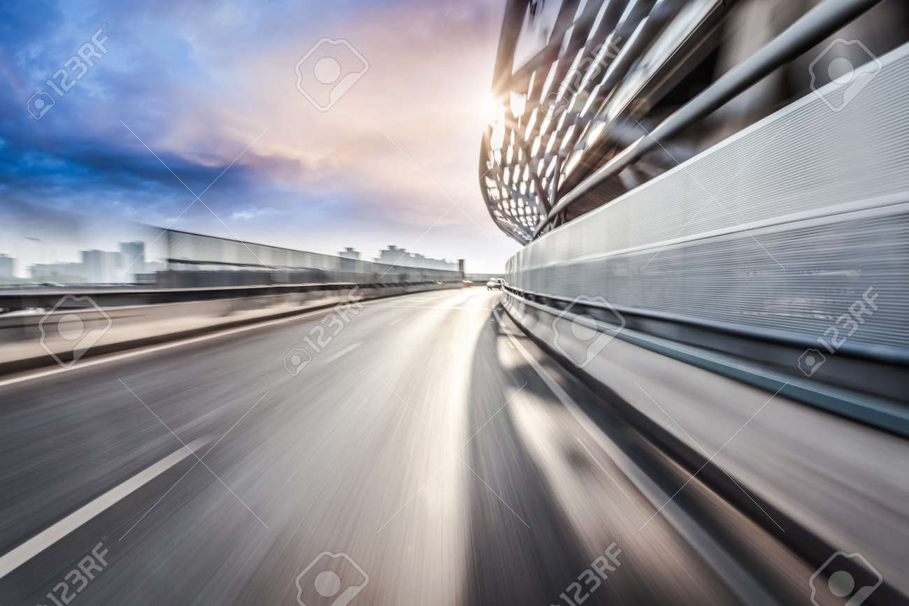 Car driving on road in city background, motion blur - 52408452 Car driving on road in city background, motion blur - 52408452