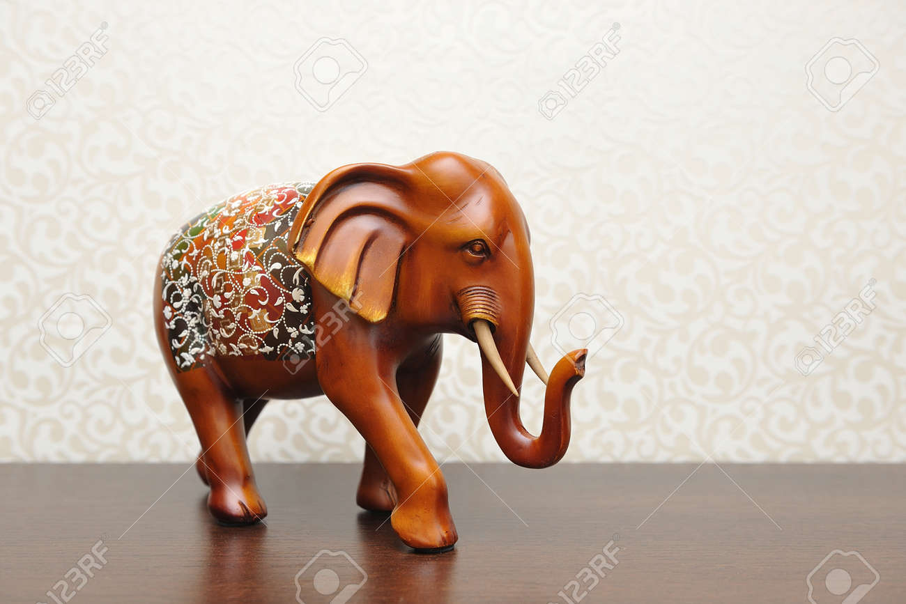 wooden figure of an elephant in a home interior brown color stock