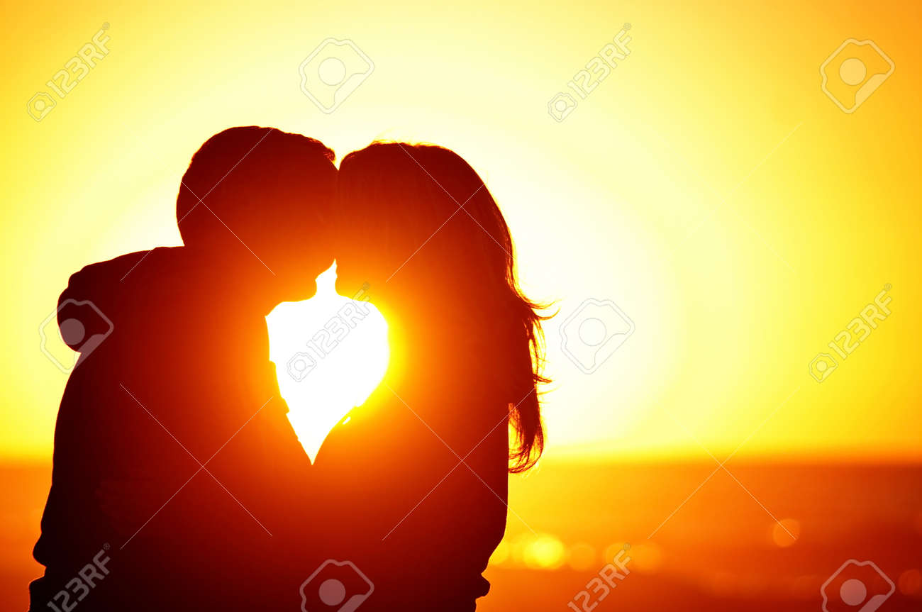 A Couple On The Beach With Sunset Background Stock Photo Picture And Royalty Free Image Image