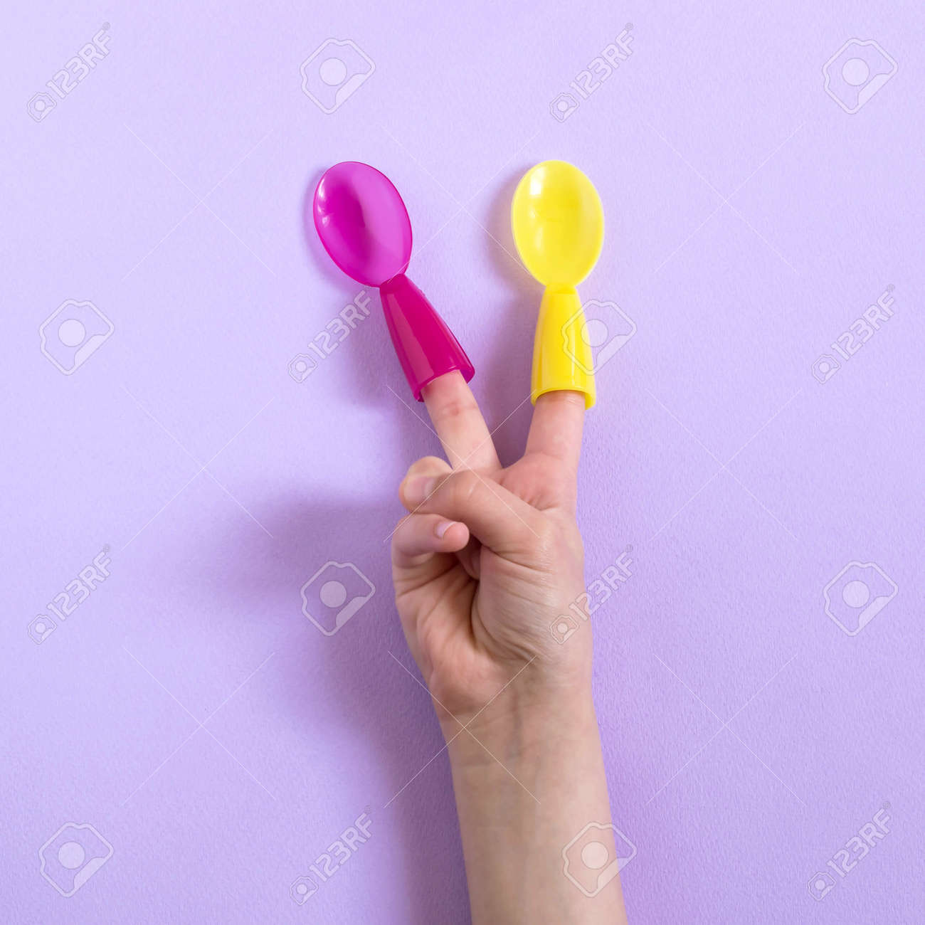 Child With Multi Colored Spoons On His Fingers Shows Sign Of