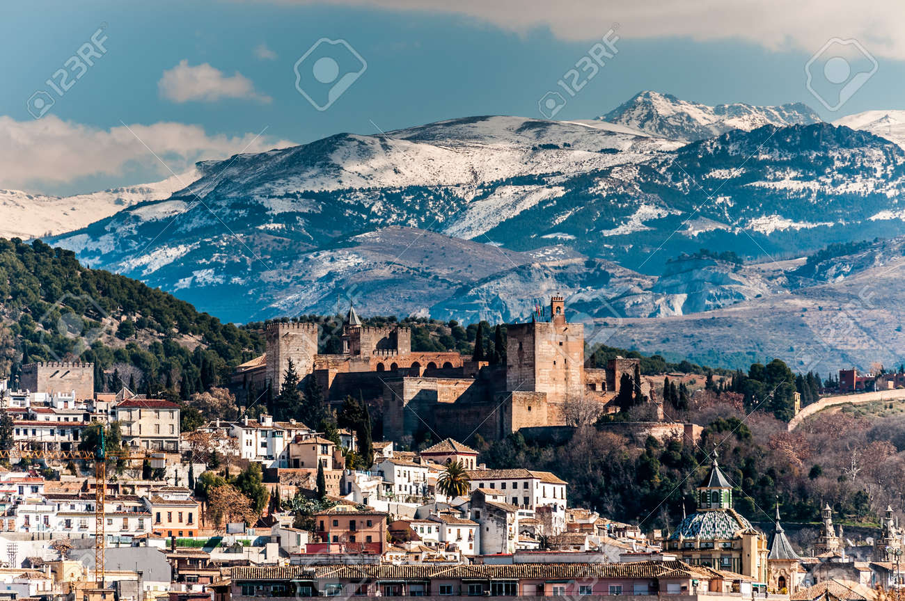 winter view of famous alhambra in front of sierra nevada mountains