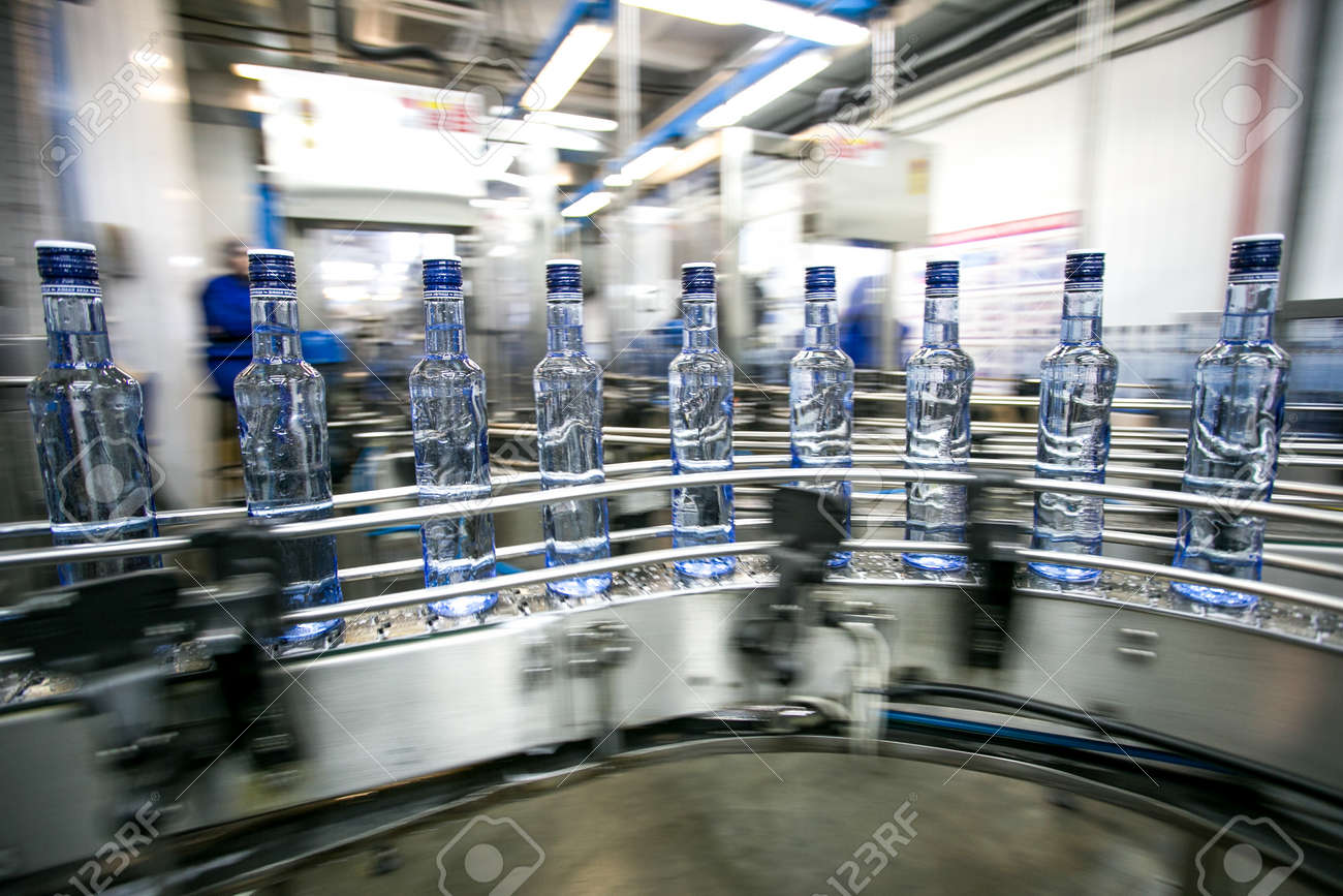 Many bottles on conveyor belt in factory, production of russian traditional alcohol drink vodka - 53136682 Many bottles on conveyor belt in factory, production of russian traditional alcohol drink vodka - 53136682