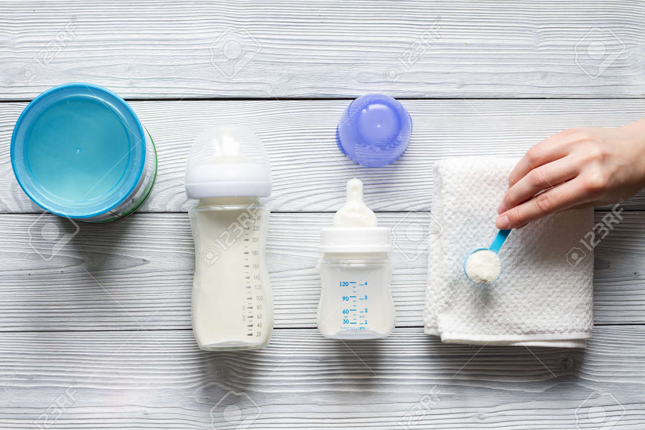 preparation of mixture baby feeding on wooden background top view - 68670244 preparation of mixture baby feeding on wooden background top view - 68670244