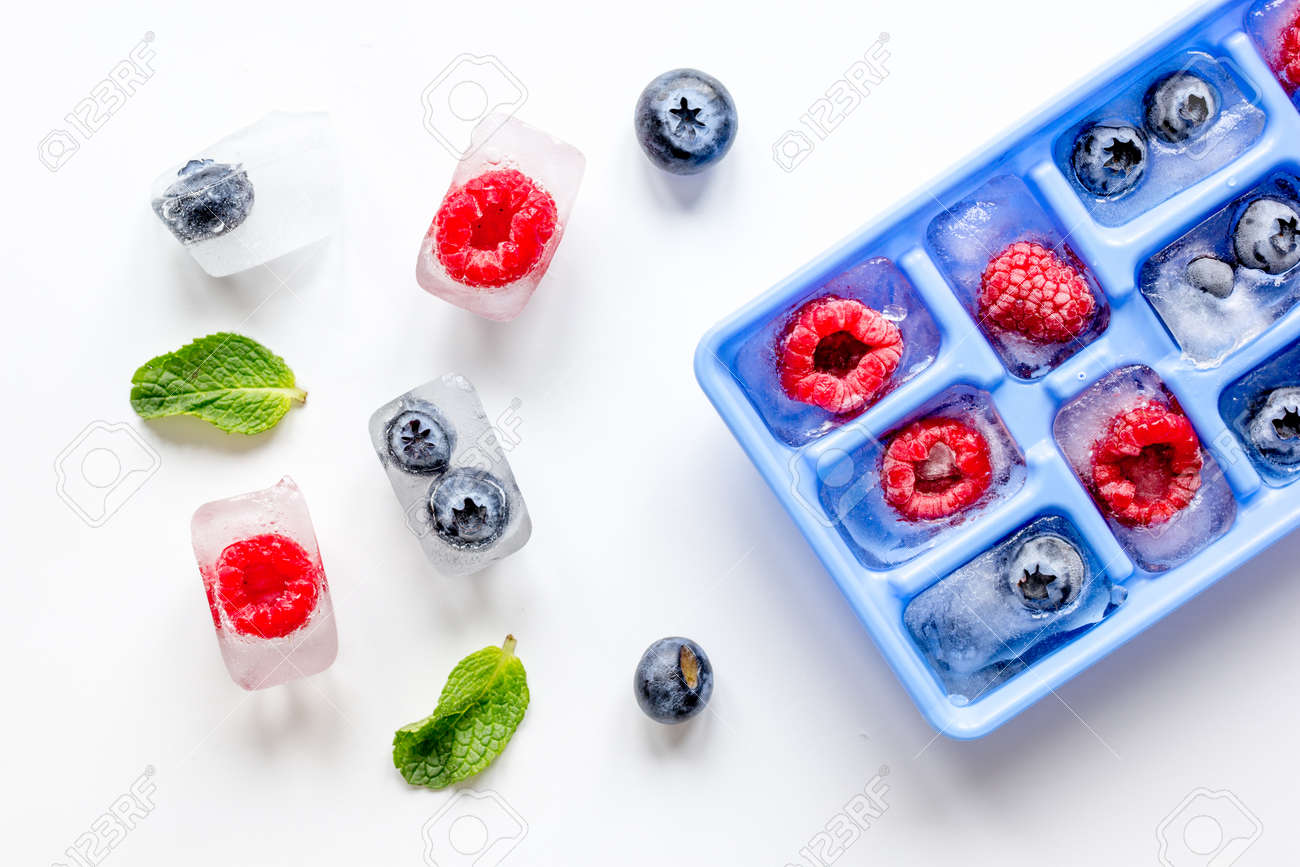 blueberry and raspberry in icetray on stone background top view - 72130709 blueberry and raspberry in icetray on stone background top view - 72130709