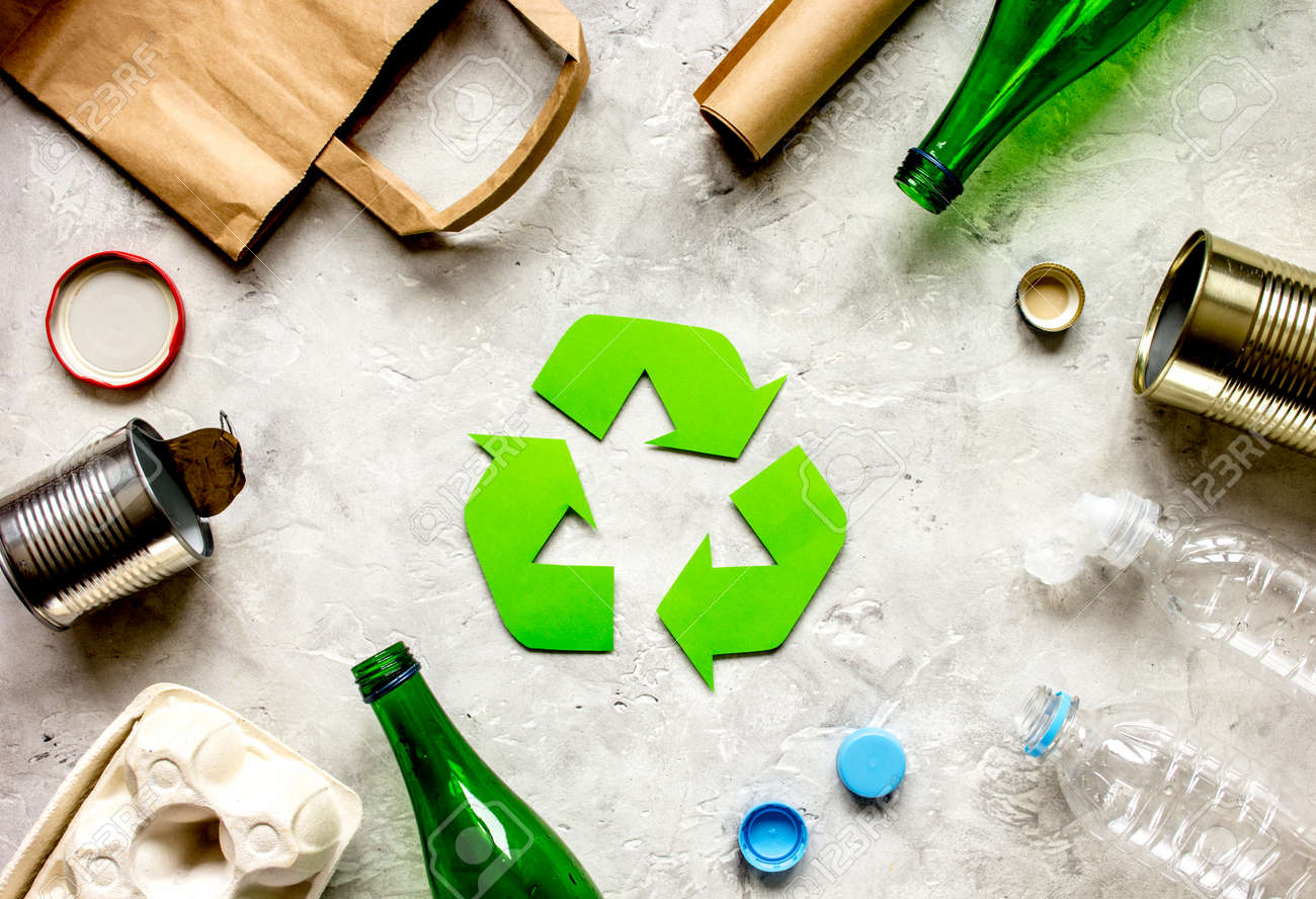waste recycling symbol with garbage on stone background top view - 73356524 waste recycling symbol with garbage on stone background top view - 73356524