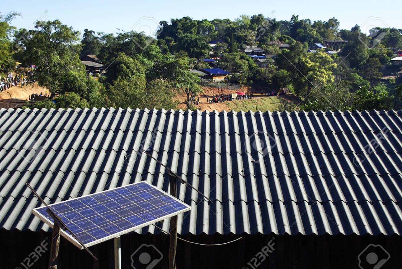 Solar Panel System On House Roof, Sunny Blue Sky Background Stock