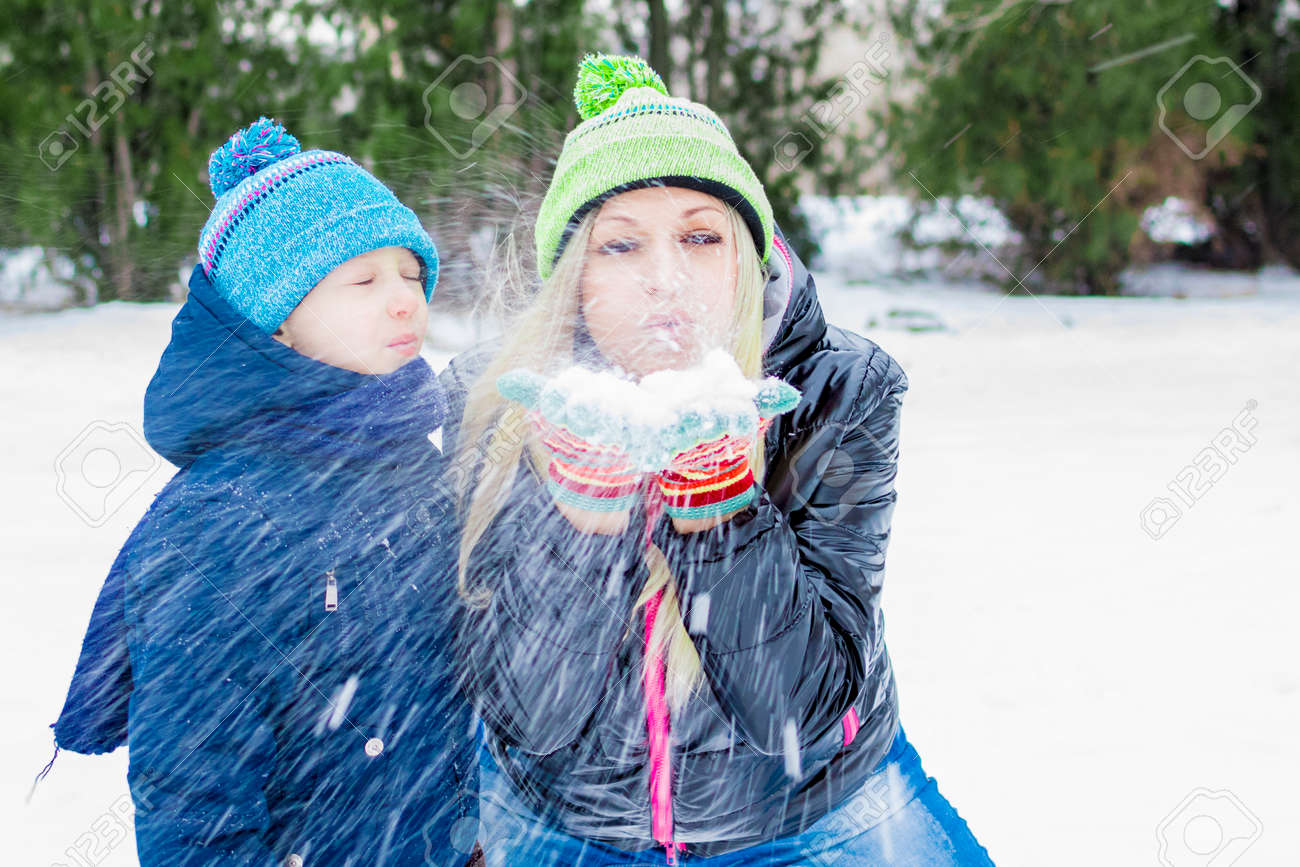 Happy Little Cute Baby And Mother On A Sunny Winter Day Playing