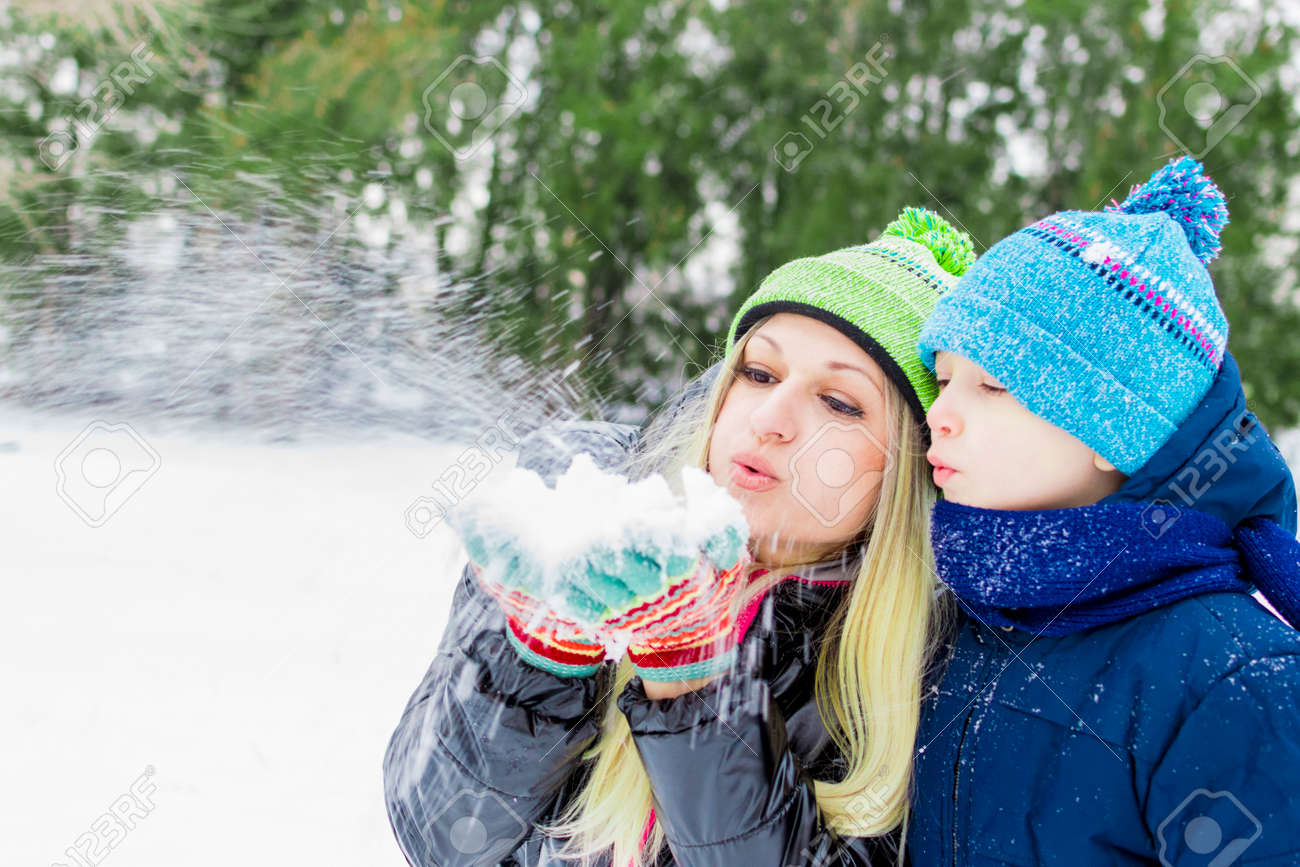 Happy Little Cute Baby And Mother On A Sunny Winter Day Playing