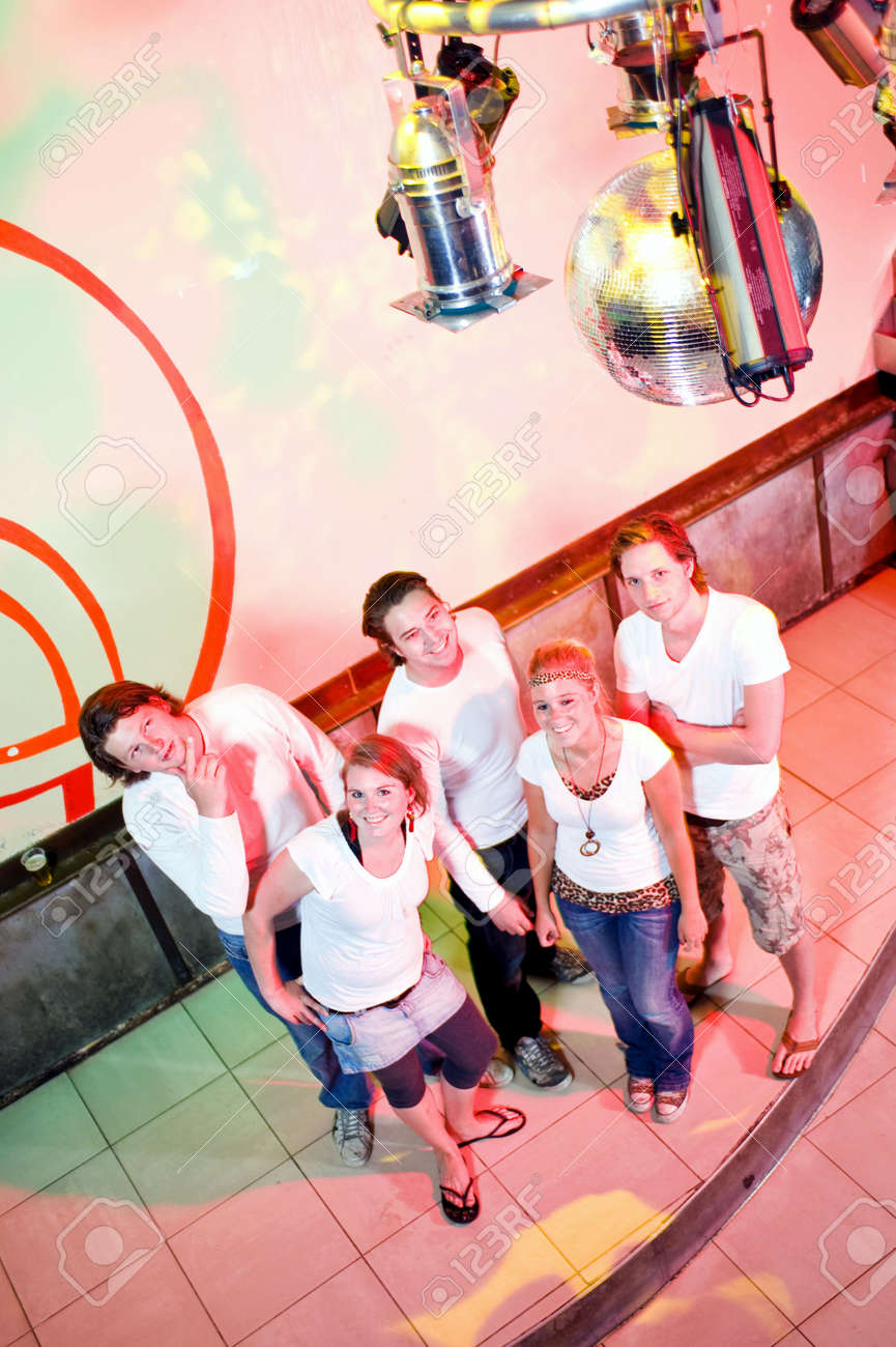 Group Of Five Young Adults On The Dance Floor In A Nightclub