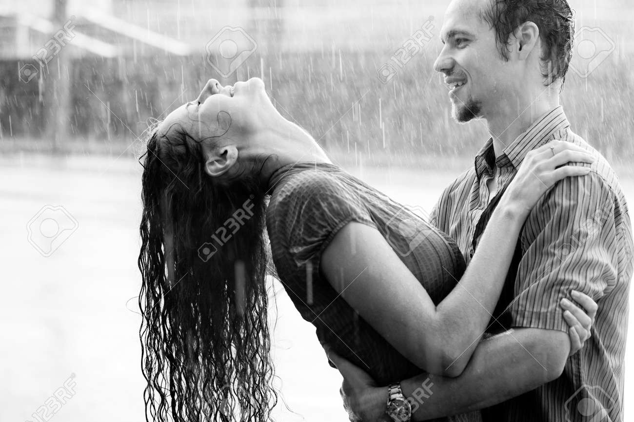 love in the rain boy and a girl kissing and hugging in the warm
