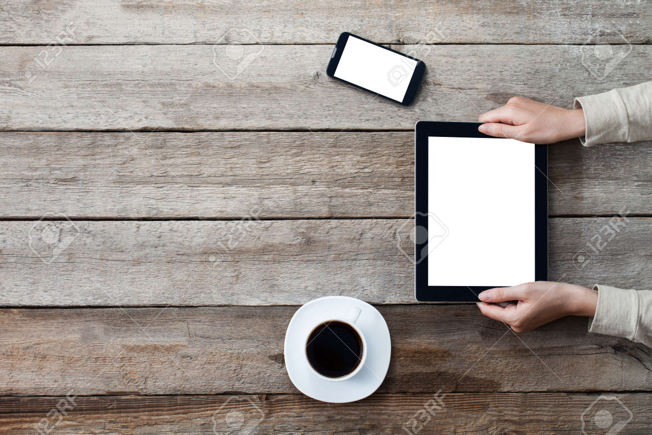 female hands holding digital tablet computer with isolated screen over old grey wooden background table. - 43458622 female hands holding digital tablet computer with isolated screen over old grey wooden background table. - 43458622
