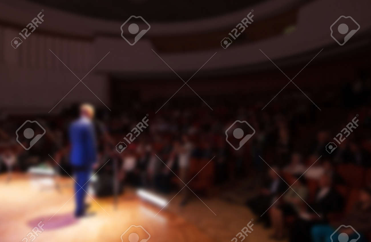 blurred image of a businessman giving a presentation in a conference/meeting - 47053377 blurred image of a businessman giving a presentation in a conference/meeting - 47053377