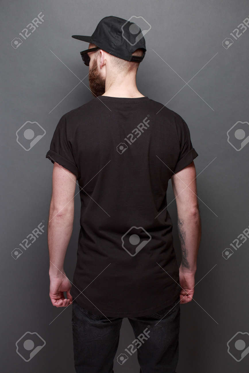 Hipster handsome male model with beard wearing black blank t-shirt with space for your logo or design over gray background - 96666673 Hipster handsome male model with beard wearing black blank t-shirt with space for your logo or design over gray background - 96666673