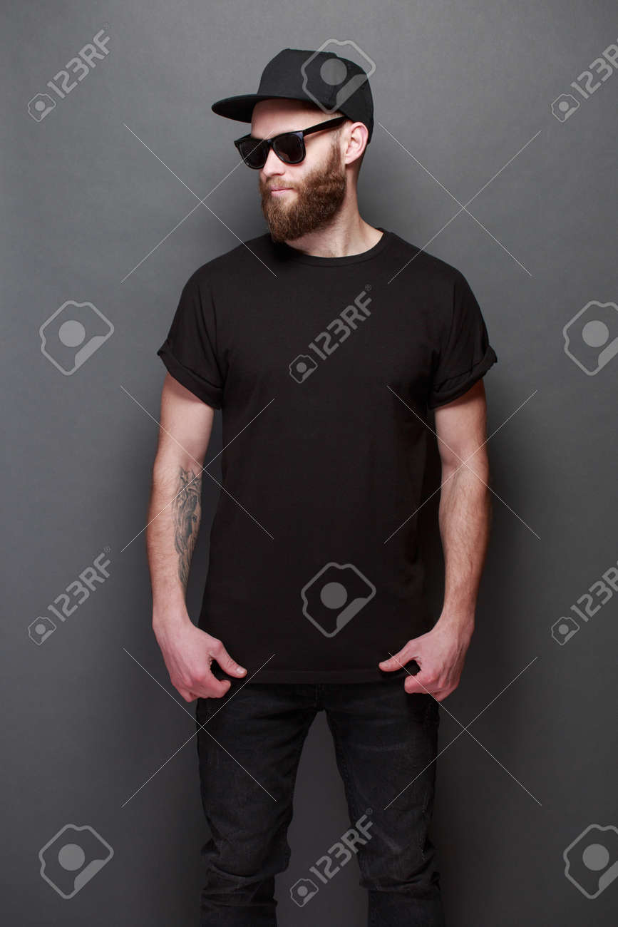 Hipster handsome male model with beard wearing black blank t-shirt with space for your design over gray background - 96828045 Hipster handsome male model with beard wearing black blank t-shirt with space for your design over gray background - 96828045